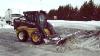 New Holland Skid Steer Loader Plowing Snow
